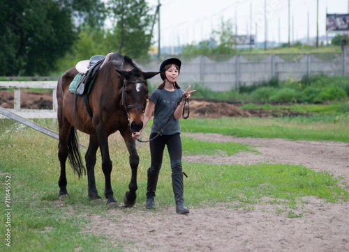 Teenage girl leading a horse