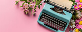 Old vintage blue typewriter with colorful spring flowers on pink background. Love concept. Greeting card, banner, poster, flyer for Valentine's, Mother's and Women's day