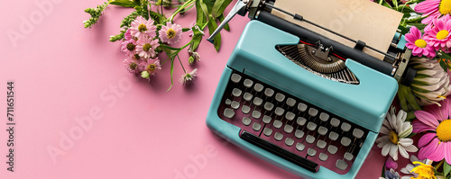 Old vintage blue typewriter with colorful spring flowers on pink background. Love concept. Greeting card, banner, poster, flyer for Valentine's, Mother's and Women's day photo