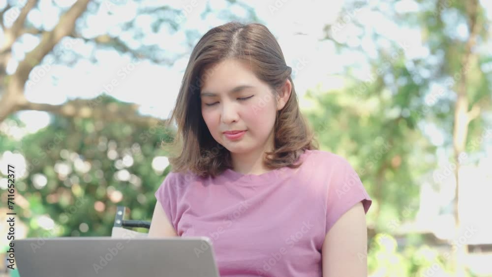 Young Asian woman typing on laptop computer at cafe. work from anywhere concept Young Asian woman typing on laptop computer at cafe. work from anywhere concept