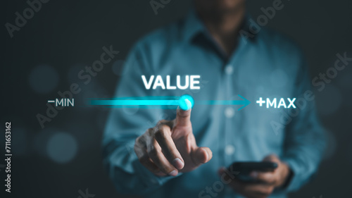 The concept of business value added. Businessman touching virtual progress bar with the word value for business growth. increase value, company value add, growth plan, Grow sales product and service. photo