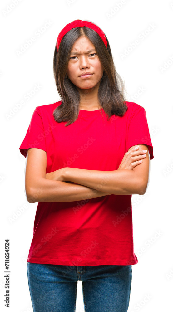 Young asian woman over isolated background skeptic and nervous, disapproving expression on face with crossed arms. Negative person. Young asian woman over isolated background skeptic and nervous, disapproving expression on face with crossed arms. Negative person.