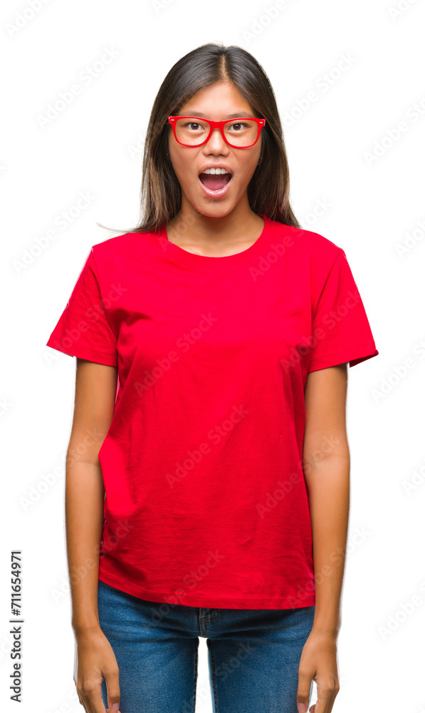 Young asian woman wearing glasses over isolated background afraid and shocked with surprise expression, fear and excited face. Young asian woman wearing glasses over isolated background afraid and shocked with surprise expression, fear and excited face.