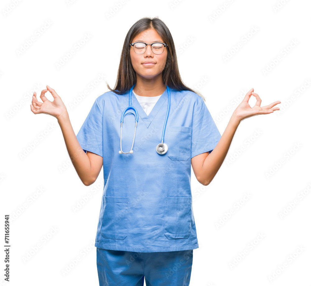 Young asian doctor woman over isolated background relax and smiling with eyes closed doing meditation gesture with fingers. Yoga concept. Young asian doctor woman over isolated background relax and smiling with eyes closed doing meditation gesture with fingers. Yoga concept.