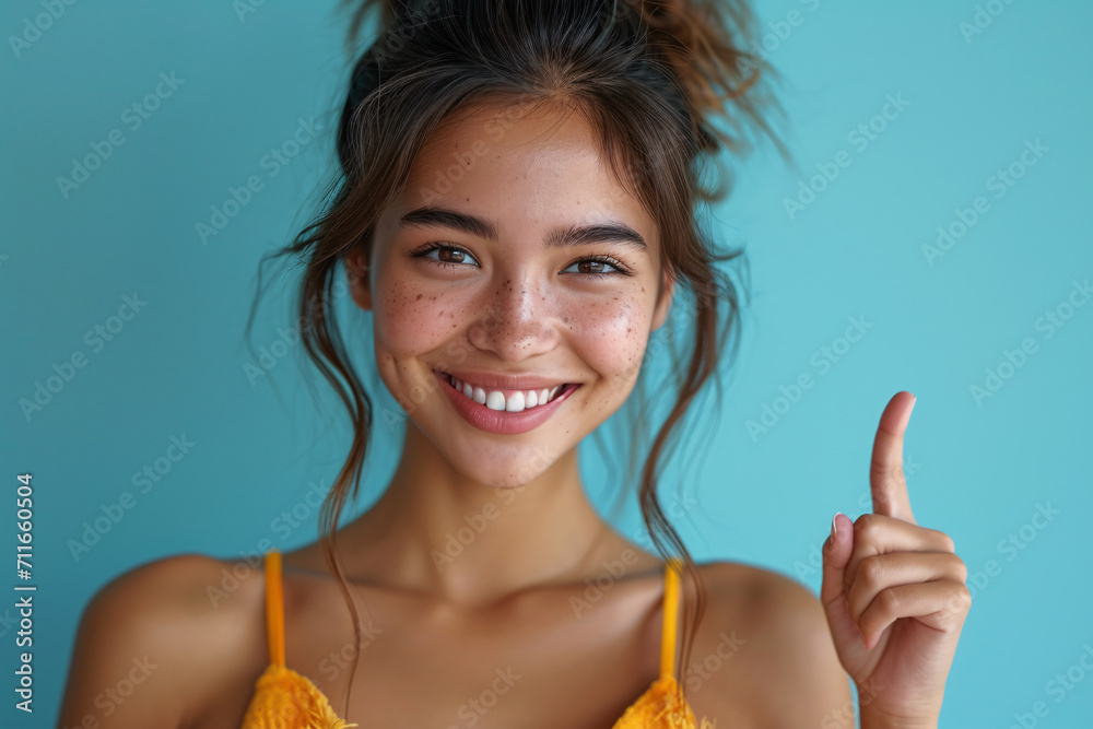 Joyful woman giving thumbs up on turquoise background Joyful woman giving thumbs up on turquoise background