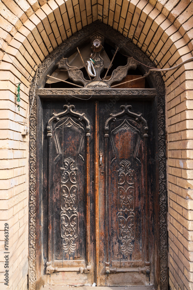 An old  wooden carved door an old house in old Basra, Iraq. Details