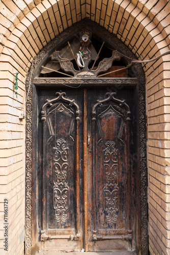 An old wooden carved door an old house in old Basra, Iraq. Details