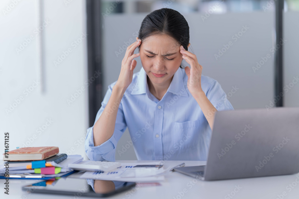 Sharing good business news. Attractive young businesswoman talking on the mobile phone and smiling while sitting at her working place in office and looking at laptop PC. Sharing good business news. Attractive young businesswoman talking on the mobile phone and smiling while sitting at her working place in office and looking at laptop PC.