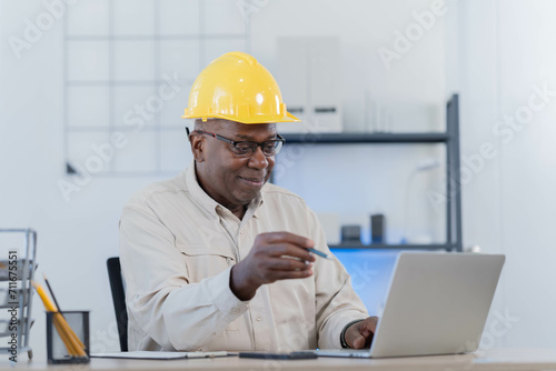  male construction engineer worker project manager with tablet pc at an indoors building site. photo