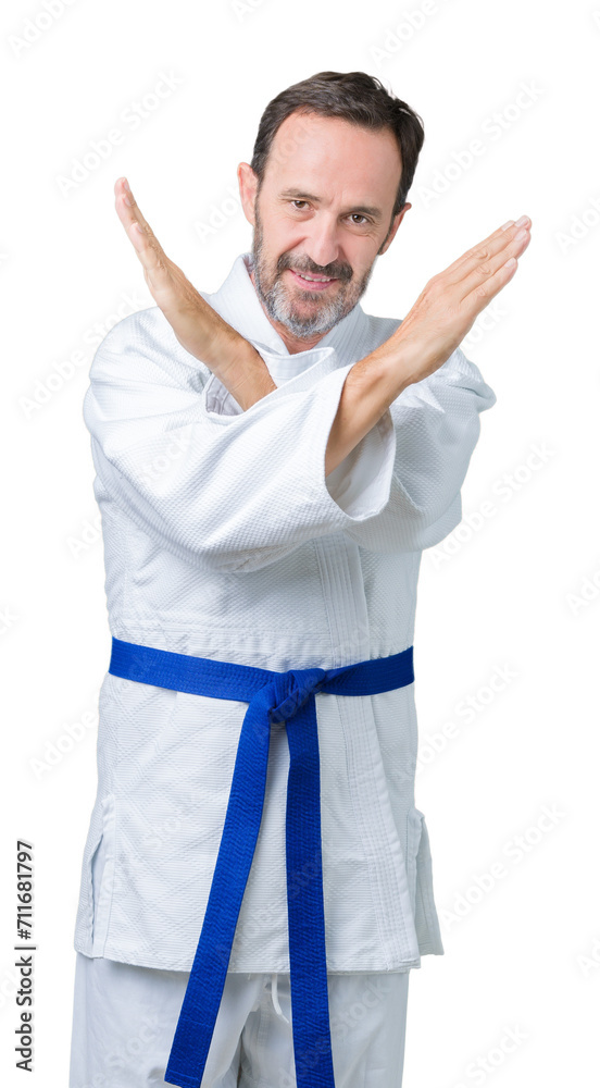 Handsome middle age senior man wearing kimono uniform over isolated background Rejection expression crossing arms doing negative sign, angry face Handsome middle age senior man wearing kimono uniform over isolated background Rejection expression crossing arms doing negative sign, angry face