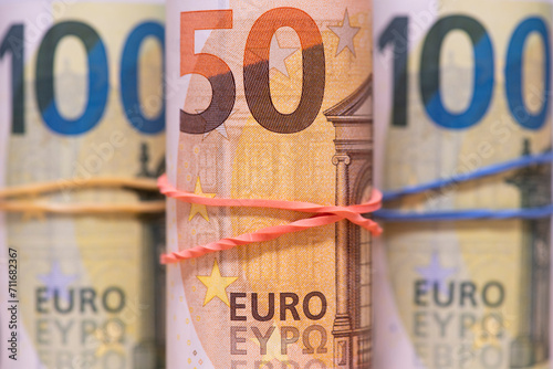 Fifty and one hundred euro bills in rolls.