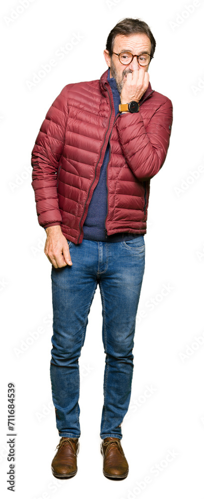 Middle age handsome man wearing glasses and winter coat looking stressed and nervous with hands on mouth biting nails. Anxiety problem. Middle age handsome man wearing glasses and winter coat looking stressed and nervous with hands on mouth biting nails. Anxiety problem.