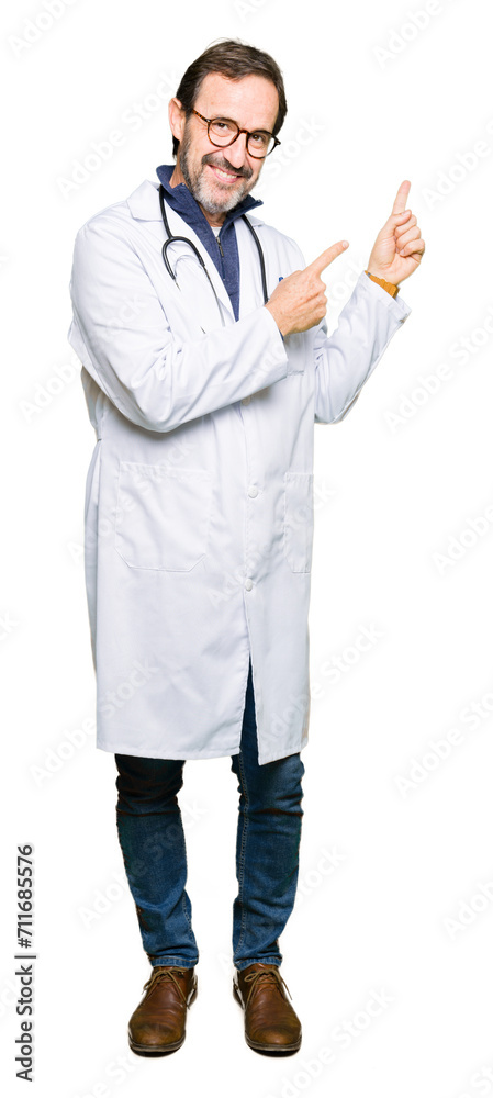 Handsome middle age doctor man wearing medical coat smiling and looking at the camera pointing with two hands and fingers to the side.