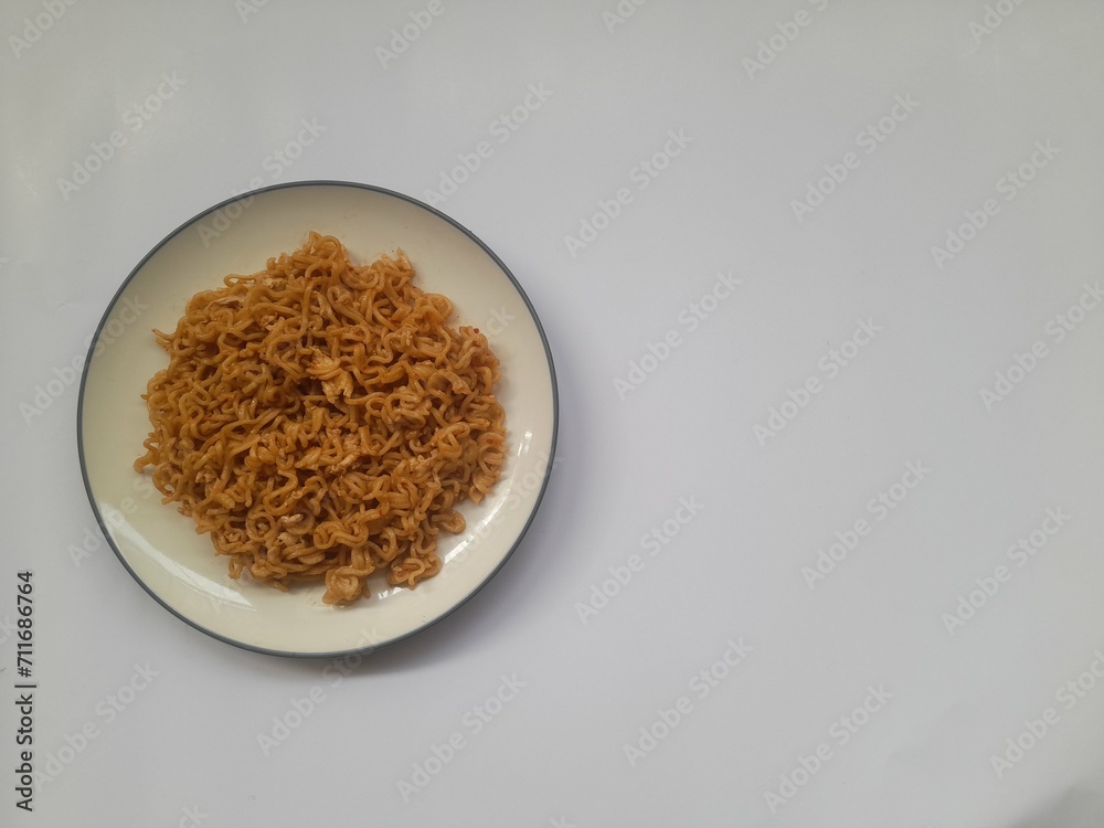 fried noodle (mie goreng) food on plate on white background. background concept of healthy food, food recipe, dish, meal, cuisine, breakfast, culinary, lunch, lifestyle, gourmet,eat,cook,carbohydrates fried noodle (mie goreng) food on plate on white background. background concept of healthy food, food recipe, dish, meal, cuisine, breakfast, culinary, lunch, lifestyle, gourmet,eat,cook,carbohydrates