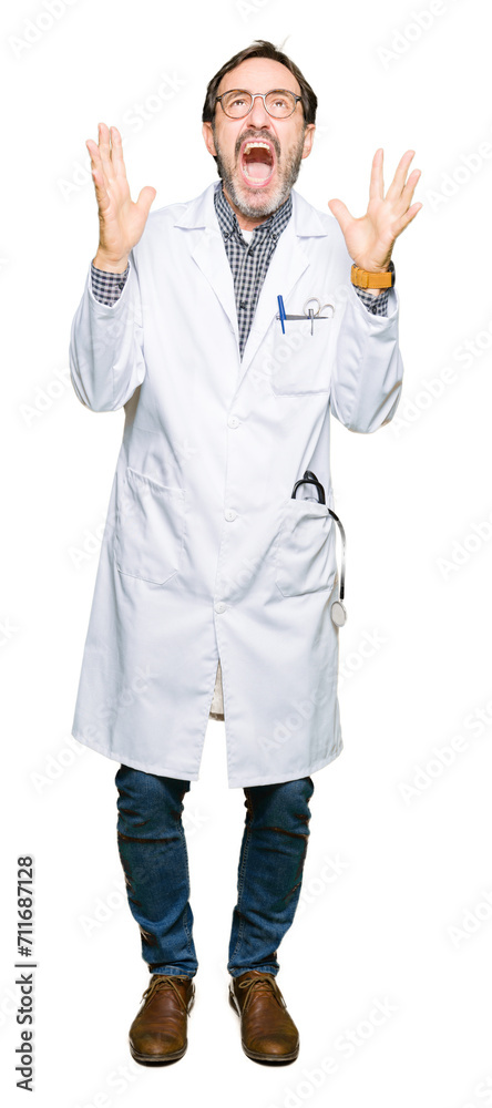 Middle age doctor men wearing medical coat crazy and mad shouting and yelling with aggressive expression and arms raised. Frustration concept. Middle age doctor men wearing medical coat crazy and mad shouting and yelling with aggressive expression and arms raised. Frustration concept.