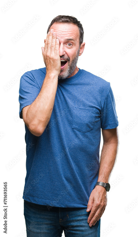 Middle age hoary senior man over isolated background covering one eye with hand with confident smile on face and surprise emotion. Middle age hoary senior man over isolated background covering one eye with hand with confident smile on face and surprise emotion.