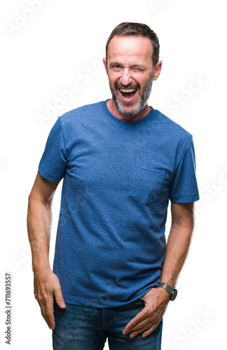 Middle age hoary senior man over isolated background winking looking at the camera with sexy expression, cheerful and happy face.