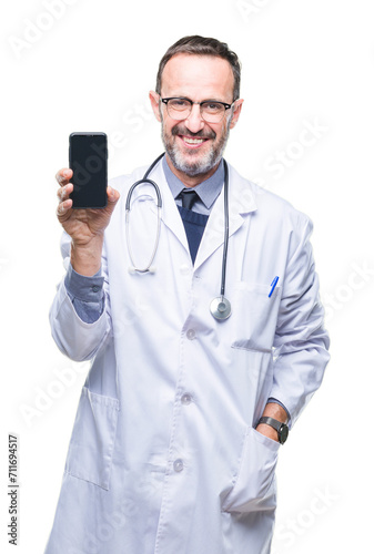 Middle age senior hoary doctor man showing smartphone screen over isolated background with a happy face standing and smiling with a confident smile showing teeth