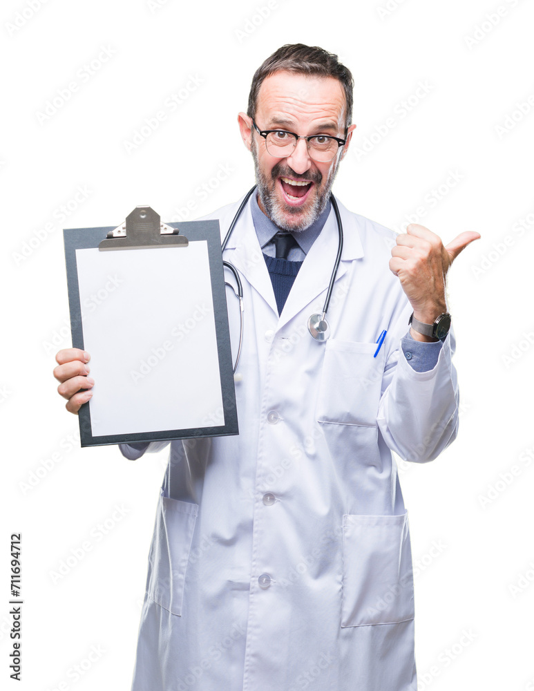 Middle age senior hoary doctor man holding clipboard isolated background pointing and showing with thumb up to the side with happy face smiling