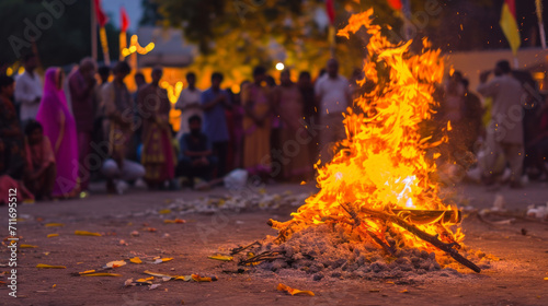 Holika Dahan Festival. Close-up of bonfire and blurred people in background. photo