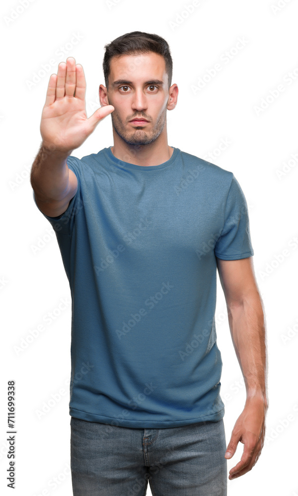 Handsome young casual man doing stop sing with palm of the hand. Warning expression with negative and serious gesture on the face. Handsome young casual man doing stop sing with palm of the hand. Warning expression with negative and serious gesture on the face.