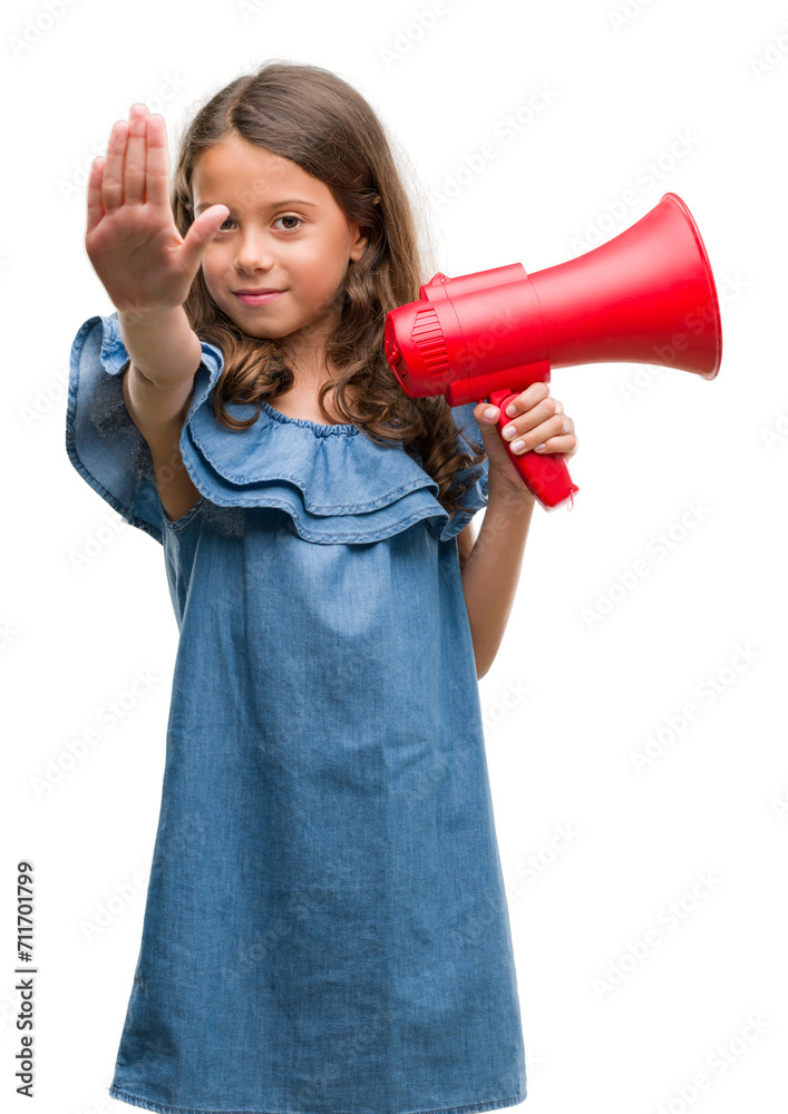 Brunette hispanic girl holding red megaphone with open hand doing stop sign with serious and confident expression, defense gesture Brunette hispanic girl holding red megaphone with open hand doing stop sign with serious and confident expression, defense gesture