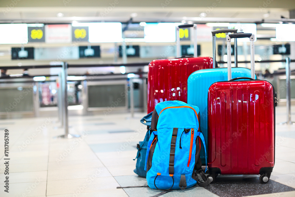 Obraz premium Stack of travelers luggage in airport terminal