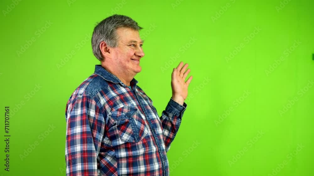 Senior man waves palm for greeting or goodbye sign Senior man waves palm for greeting or goodbye sign