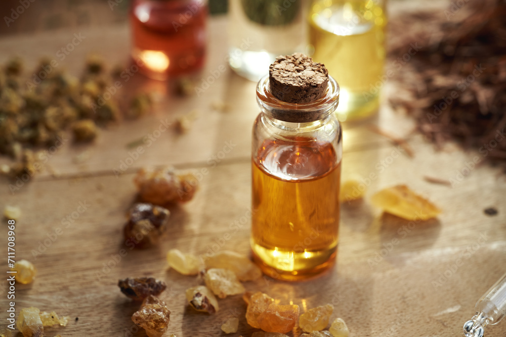 Frankincense essential oil and resin on a wooden table