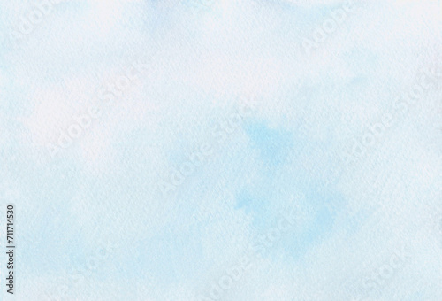 Light blue watercolor abstract background hand-drawn with space for text. A banner for design and decoration. The texture of watercolor on paper. An illustration of the sky with a gradient.