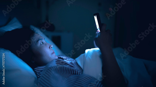 Asian woman playing game on smartphone in the bed at night,Thailand people,Addict social media photo