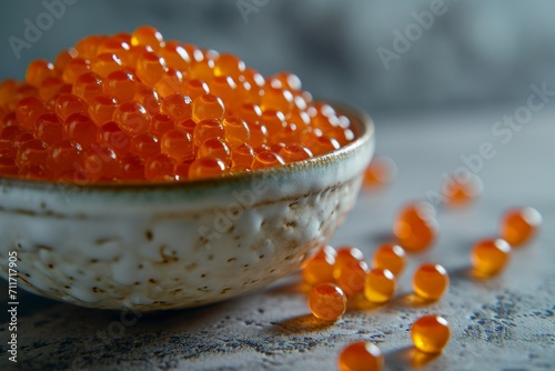 Red caviar in vintage ceramic bowl with greenery, close up, gray background
