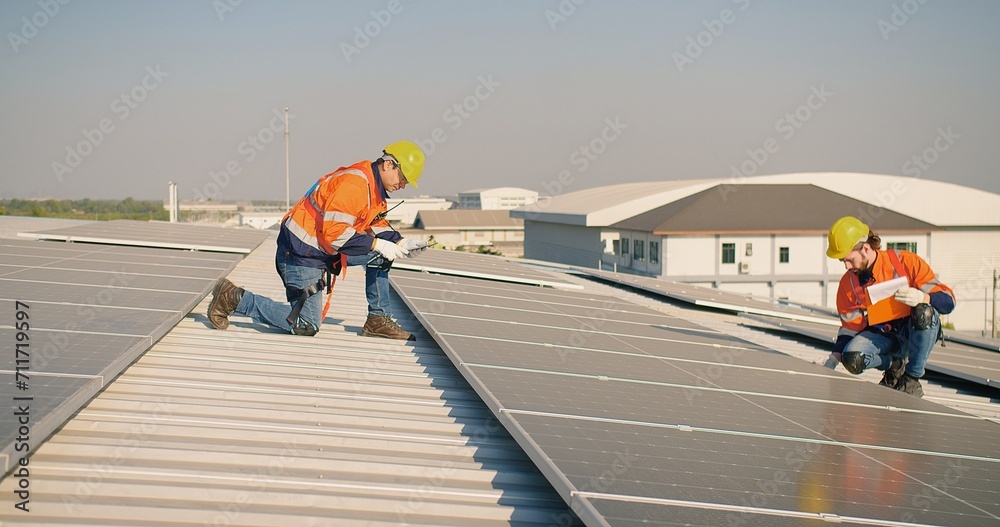 engineer man contractor worker architect construction manager in uniform and hardhat work to maintenance checking an operation and efficiency performance of photovoltaic solar panels on roof