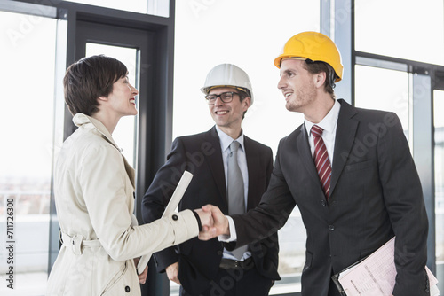 developer, owner and architect of new building inspecting the progress