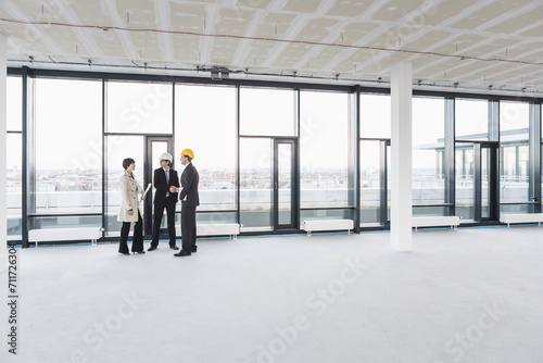 developer, owner and architect of new building inspecting the progress