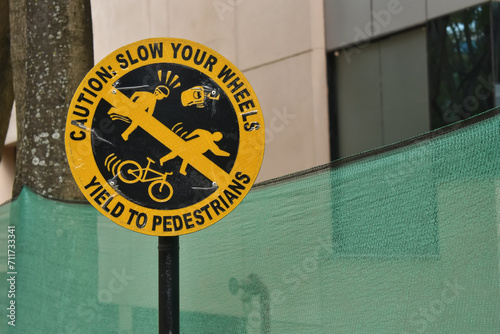 A closeup sign board banning movement of cycle or vehicle on pavement. photo