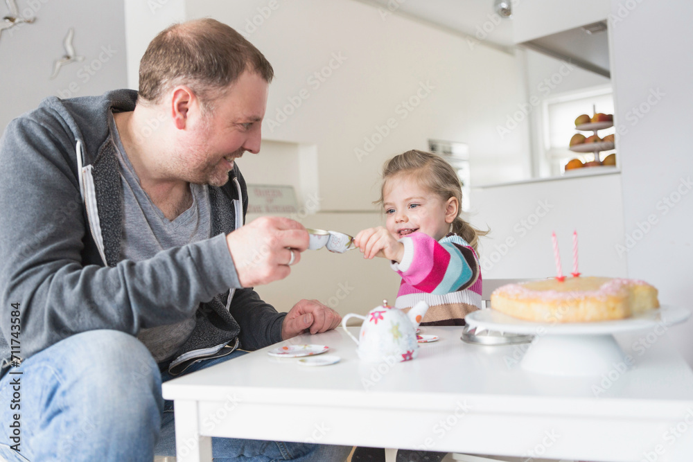Father and his daughter celebrating her second birthday together. Munich, Bavaria, Germany Father and his daughter celebrating her second birthday together. Munich, Bavaria, Germany