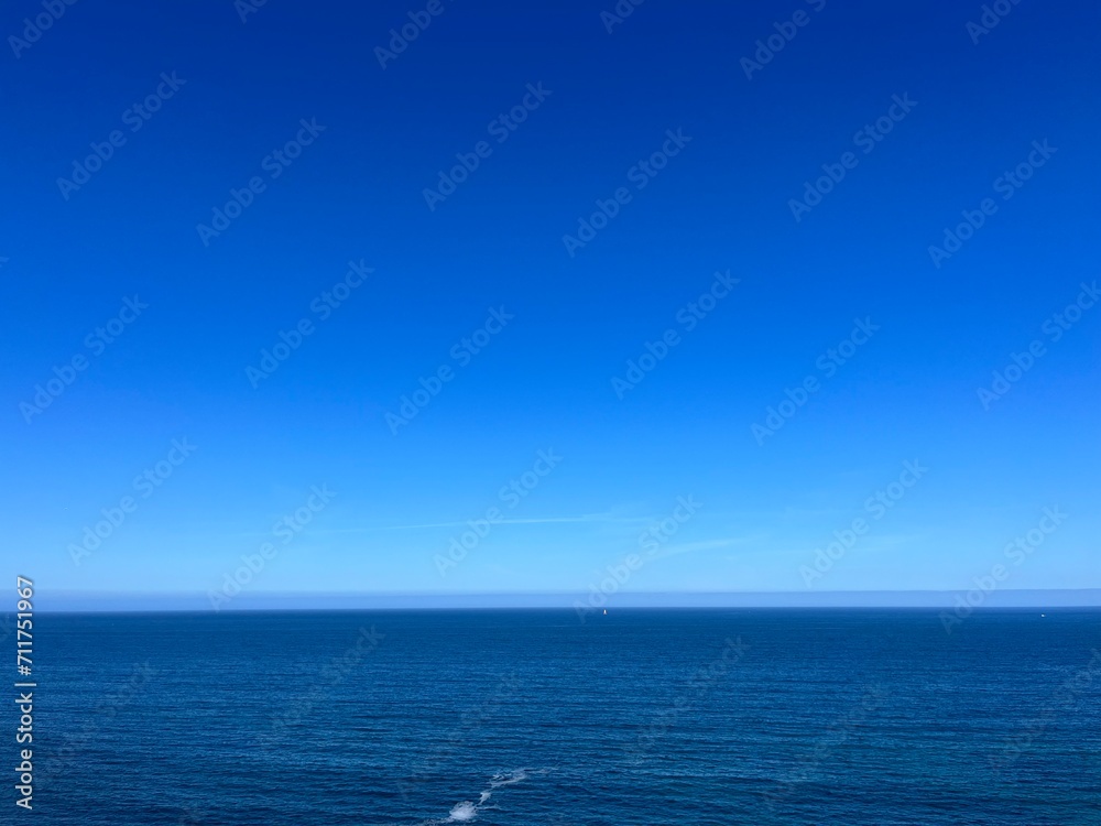Blue seascape background, clear blue sky and blue sea horizon, natural colors Blue seascape background, clear blue sky and blue sea horizon, natural colors