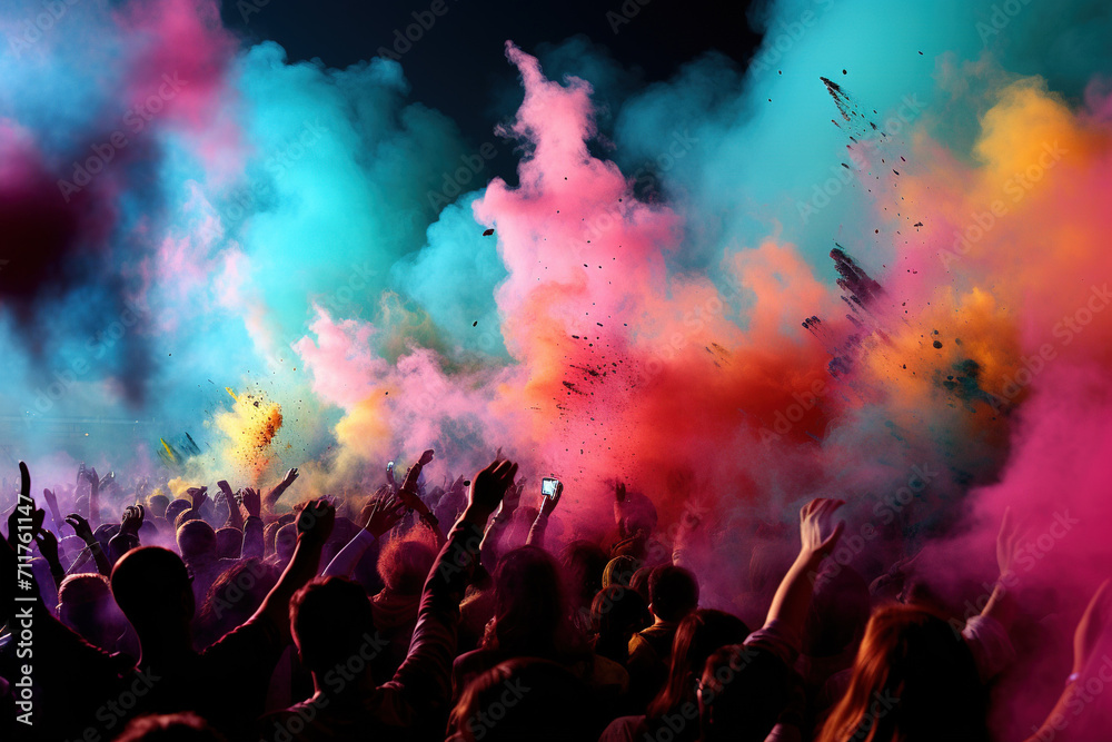 Cheerful participants in the Holi festival throw handfuls of brightly coloured powders into the air, creating a lively and colourful atmosphere. Spring and love festival.