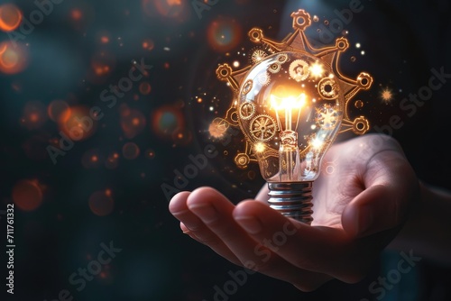 A close-up of a person hand holding a lightbulb, with visible gears and mechanisms inside Hand holding light bulb and business digital marketing innovation technology