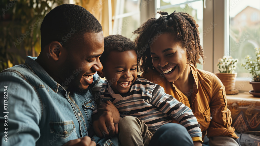 Happy family with a father, mother, and child laughing and sharing a joyful moment together on a couch. Happy family with a father, mother, and child laughing and sharing a joyful moment together on a couch.