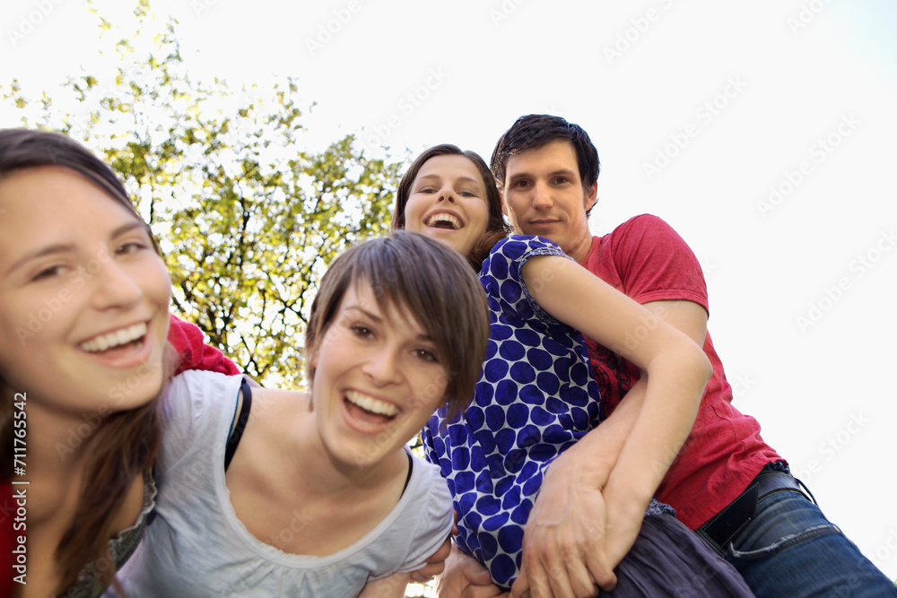 Group of students laughing and smiling while posing for the camera. Group of students laughing and smiling while posing for the camera.