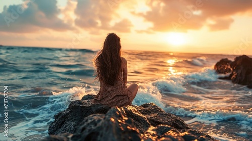 Woman with long flowing hair, sitting on a rock and gazing at the horizon on a serene beach generative ai © ThisDesign