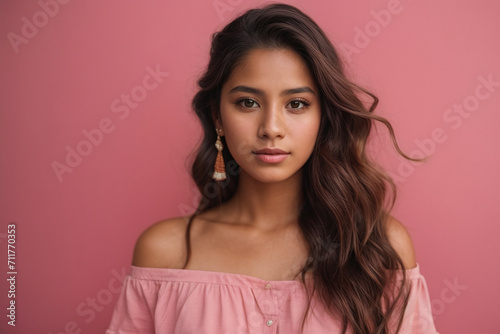 Mexican young woman portrait, black hair and pink background