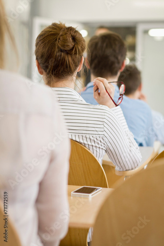 Motivational speaker and business coach holding a business coaching seminar for young professionals at a start-up business.
