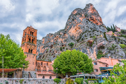 Scenic view of Moustiers-Sainte-Marie village in Provence, south of France against the french Alps and dramatic summer sky
