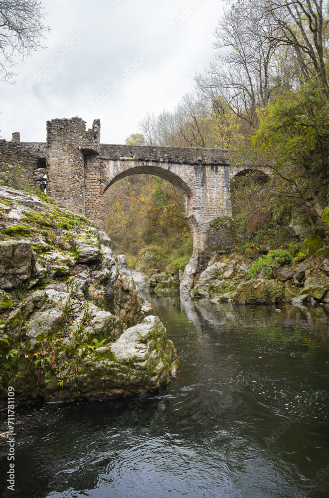 old stone bridge over river.