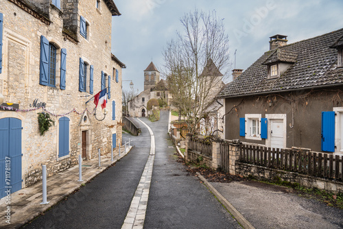 french village street with church and stone house in the background. © ChemaVelasco