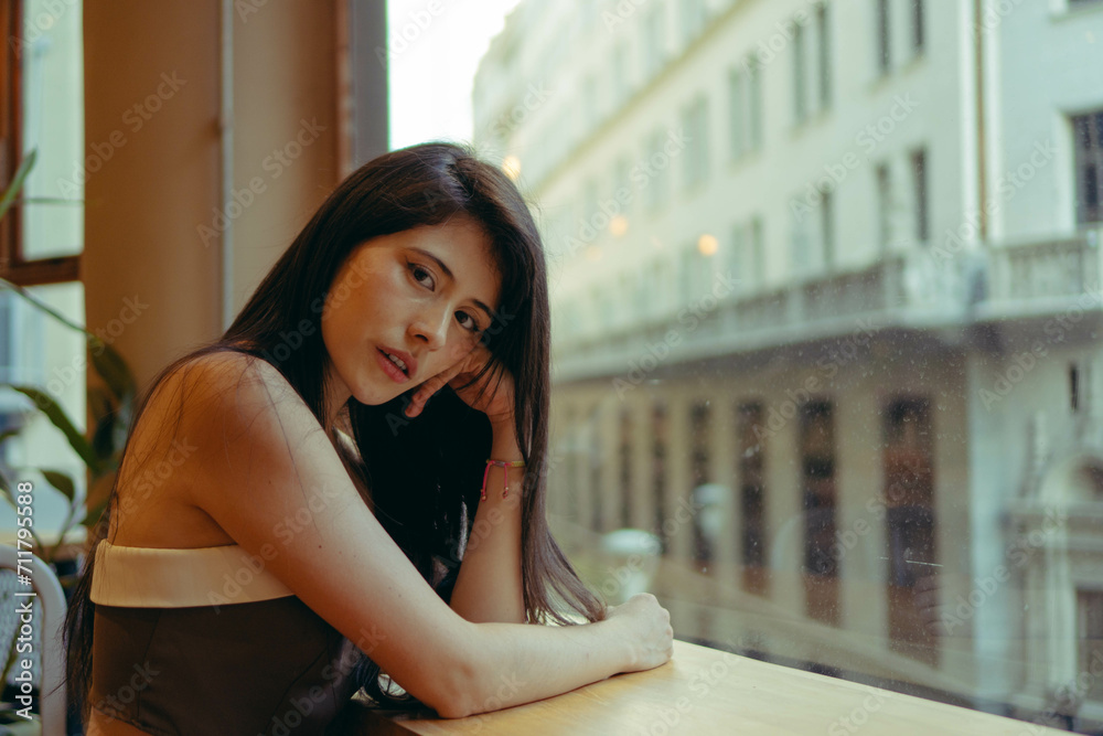 young Latin woman businesswoman looking confidently at camera in an establishment overlooking the city. copy space young Latin woman businesswoman looking confidently at camera in an establishment overlooking the city. copy space