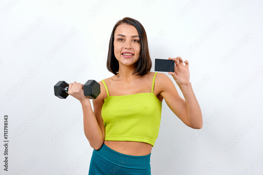 Brunette woman advertising exercise with dumbbells Brunette woman advertising exercise with dumbbells